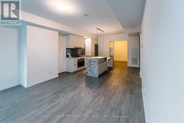 Toronto (Church-Yonge Corridor) condo for rent - A spacious living room with a television and a kitchen area in the background.