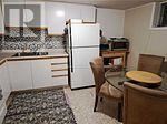 Toronto (Pleasant View) apartment for rent - A small kitchen with a refrigerator, table and chairs.