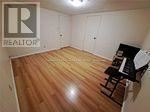 Toronto (Pleasant View) apartment for rent - A room with a wooden floor and a piano.