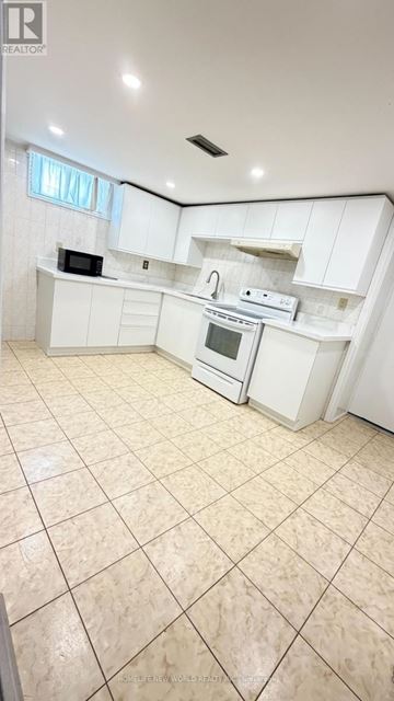Richmond Hill (Crosby) apartment for rent - A kitchen with white cabinets and appliances.