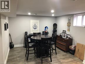 Hamilton apartment for rent - A room with a dining table and chairs, a guitar, a skateboard, and a few other items.