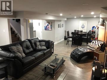 Hamilton apartment for rent - A living room with a black leather couch and a coffee table.