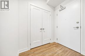 Cambridge condo for rent - A white door with a handle and a small window above it.