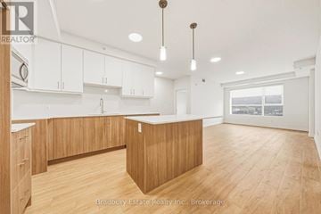 Cambridge condo for rent - A spacious kitchen with wooden cabinets and a large island.