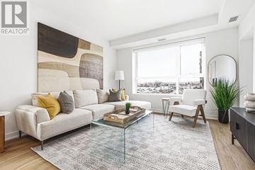 Cambridge condo for rent - A living room with a large couch and a coffee table.