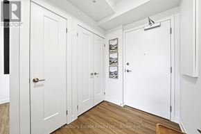 Cambridge condo for rent - A hallway with white doors and a brokerage sign.
