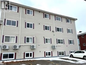 Moncton apartment for rent - A building with a car parked in front of it.