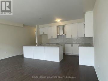Vaughan (Kleinburg) townhouse for rent - A spacious kitchen with white cabinets and a grey backsplash.