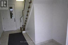 Barrie (East Bayfield) townhouse for rent - A hallway with a staircase and a door.