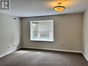 Barrie (East Bayfield) townhouse for rent - A room with a window and a carpeted floor.