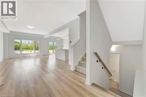 Paris townhouse for rent - A spacious room with a staircase leading to the upper floor.