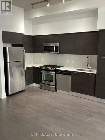 Toronto (Waterfront Communities) condo for rent - A kitchen with a refrigerator, oven, and microwave.