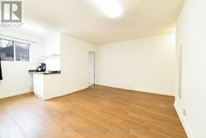 Toronto (Yonge-Eglinton) apartment for rent - A spacious room with wooden flooring and white walls, with a window on the left side.