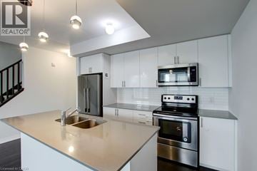 Milton townhouse for rent - A modern kitchen with a stainless steel oven and microwave.
