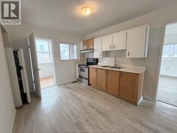 Windsor duplex for rent - A kitchen with wooden cabinets and a microwave on the counter.