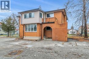Windsor duplex for rent - A two-story brick house with a balcony on the second floor.
