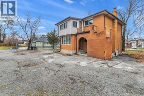 Windsor duplex for rent - A two-story brick house with a gravel driveway in front.