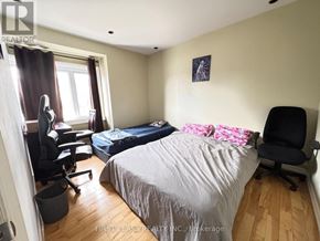 Toronto (Wexford-Maryvale) apartment for rent - A bedroom with a large bed and a large picture on the wall.