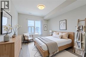 Kitchener apartment for rent - A bedroom with a large bed and a chair.