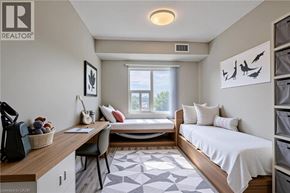 Kitchener apartment for rent - A bedroom with a bed, desk, and chair.