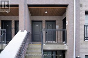 Oakville (Jm Joshua Meadows) townhouse for rent - A building with a black door and a balcony with a railing.