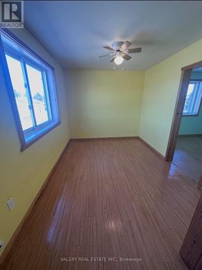 French River multi-family for rent - A room with a ceiling fan and wooden flooring.