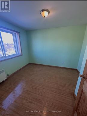 French River multi-family for rent - A room with wood flooring and a window.