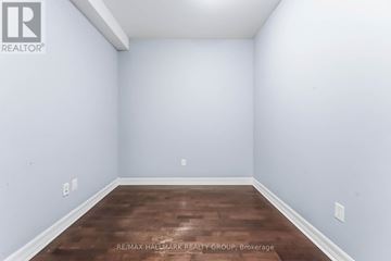 Ottawa condo for rent - A spacious living room with a green chair and sliding glass doors.
