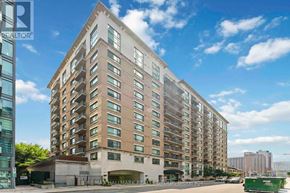 Ottawa condo for rent - A tall residential building with a clear blue sky above it.