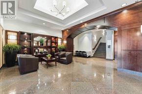 Ottawa condo for rent - A spacious lobby with a staircase and a reception desk.
