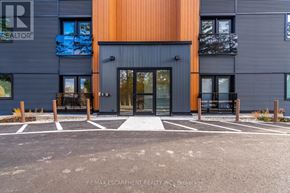 Hamilton (Stoney Creek) townhouse for rent - A modern building with a black and orange facade and a glass entrance.