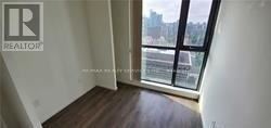 Toronto (Church-Yonge Corridor) condo for rent - A room with a window overlooking a cityscape.