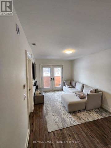Bradford West Gwillimbury (Bradford) townhouse for rent - A living room with a grey sofa and a rug.