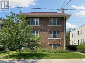 Toronto (Annex) apartment for rent - A red brick house with a tree in front.