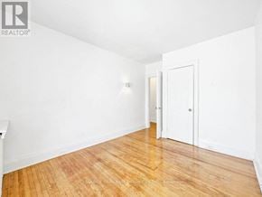 Toronto (Annex) apartment for rent - A room with wooden flooring and white walls.