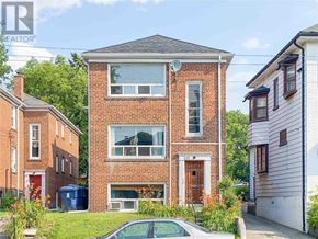 Toronto (Woodbine Corridor) apartment for rent - A brick house with a car parked in front of it.