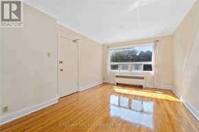 Toronto (Woodbine Corridor) apartment for rent - A room with wooden floors and a window overlooking a body of water.