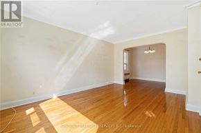 Toronto (Woodbine Corridor) apartment for rent - A room with wooden flooring and white walls.