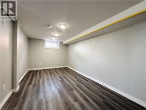 Kitchener apartment for rent - A room with wooden flooring and a window.