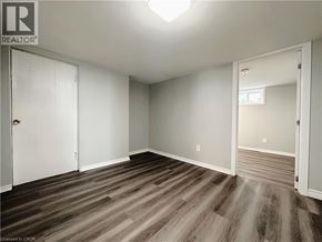 Kitchener apartment for rent - A room with wood flooring and white walls.