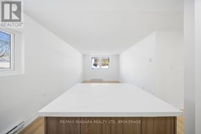 Prince Edward County (Picton Ward) multi-family for rent - A white room with a large table in the middle and a window on the left.