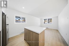Prince Edward County (Picton Ward) multi-family for rent - A kitchen with a fridge and a counter top.