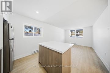 Prince Edward County (Picton Ward) multi-family for rent - A kitchen with a fridge and a counter top.