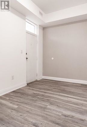 Toronto (Moss Park) multi-family for rent - A room with a white door and a wooden floor.