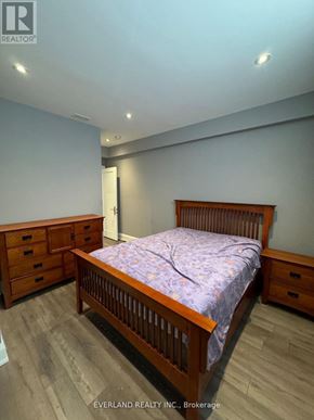 Richmond Hill (Langstaff) apartment for rent - A bedroom with a bed, dresser, and nightstand.