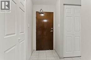 Windsor apartment for rent - A brown door is in a hallway with white walls.