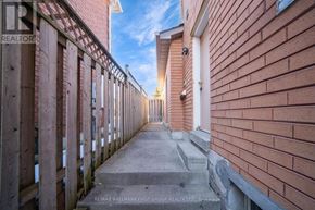 Toronto (Highland Creek) apartment for rent - A long, narrow alleyway between two red brick buildings.
