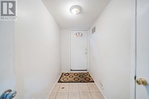 Toronto (Highland Creek) apartment for rent - A hallway with a door and a tiled floor.