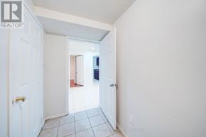 Toronto (Highland Creek) apartment for rent - A hallway with a white door and a white wall.