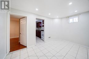 Toronto (Highland Creek) apartment for rent - A white tiled room with a doorway leading to another room.